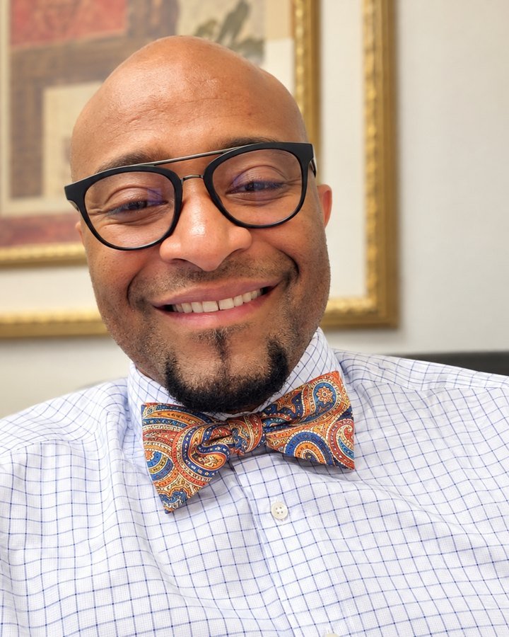 Jim Palmer, MSN, PMHNP-BC, smiling in a checked shirt and paisley bow tie